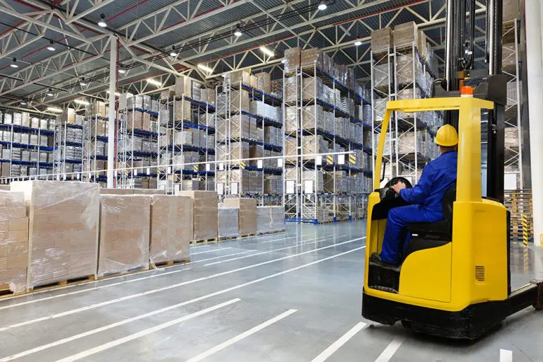 image of a man operating a forklift in a warehouse