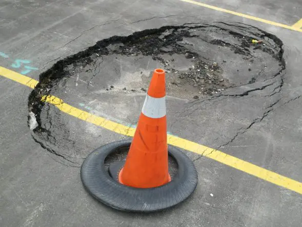 image of a pothole formed on asphalt road